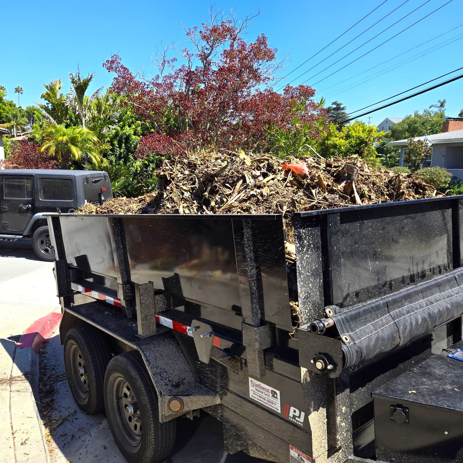 673b7f7f32dacf1517992ba6 7. A trailer filled with yard waste and debris in San Diego