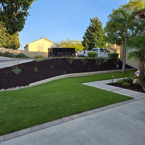 673b7ef742c2955a85ff285c 5. A San Diego backyard with lush artificial grass, a raised mulch bed p 500